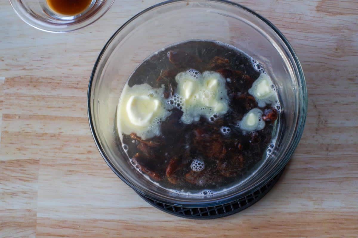 butter dates and boiling water in medium glass bowl