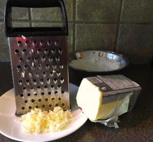 cheese grater being used to 'cut butter into recipe'