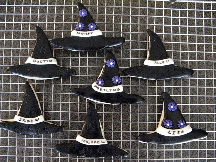 fondant covered Halloween witch hat cookies on metal cooling rack