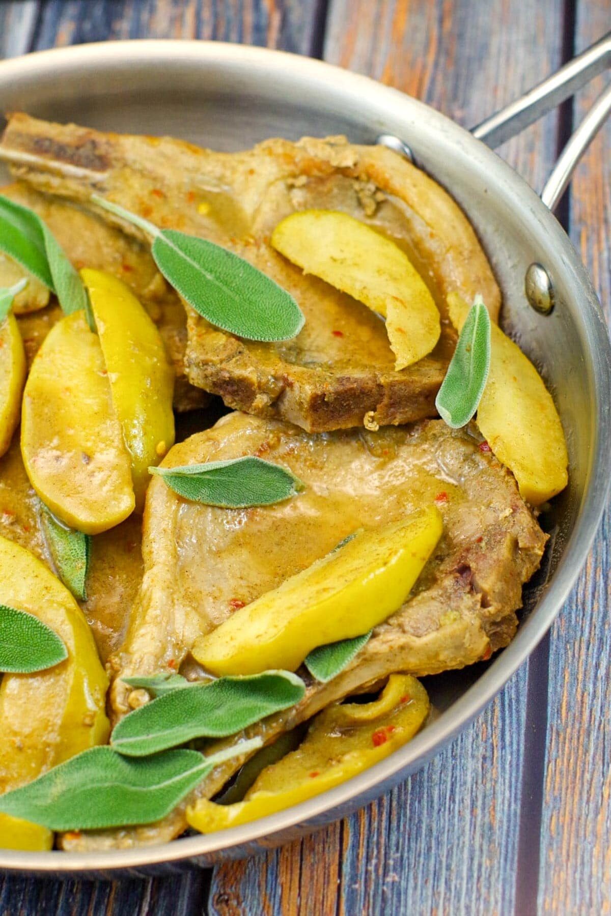½ pan of apple and pork chops with sage leaves