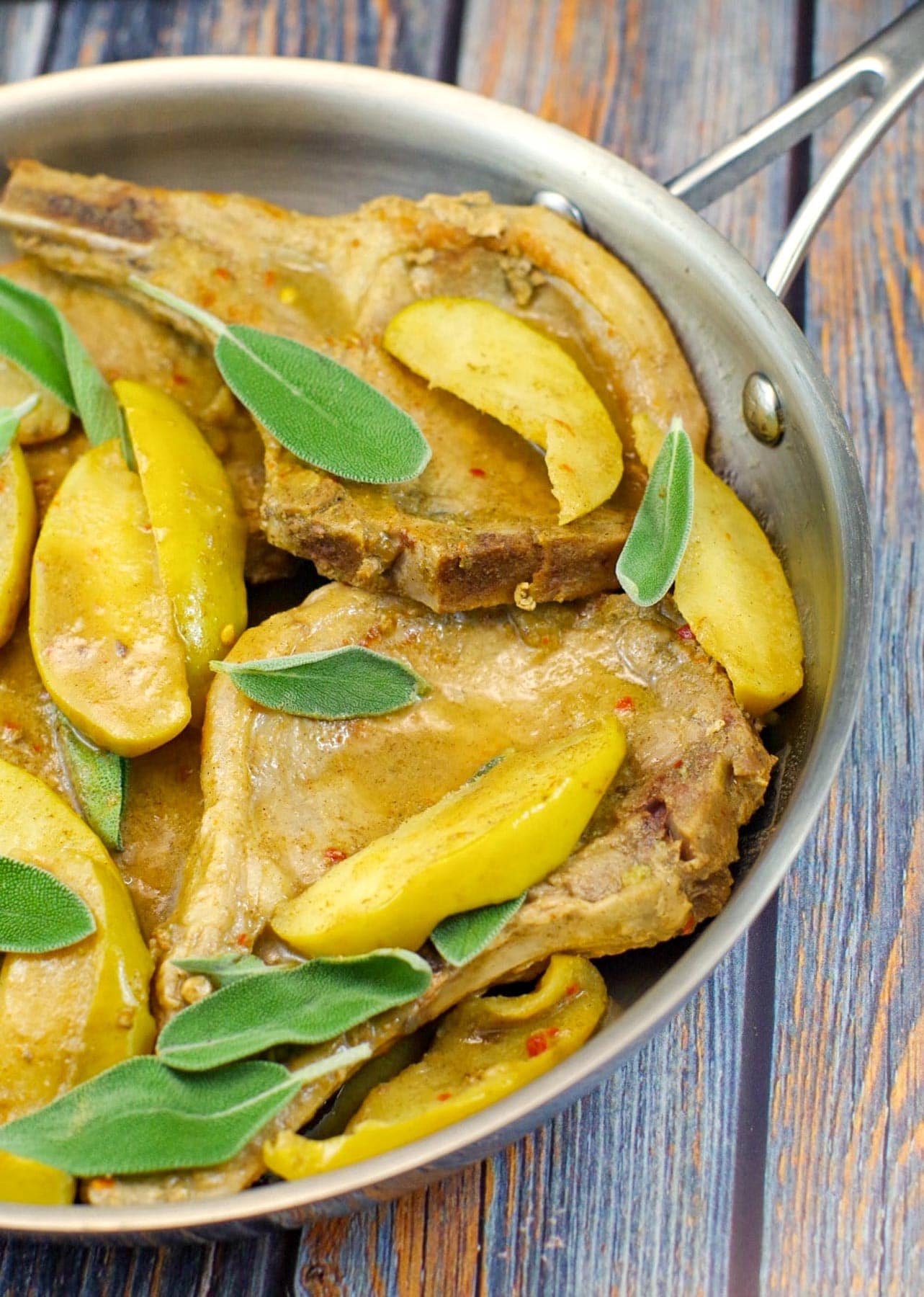 ½ pan of apple and pork chops with sage leaves
