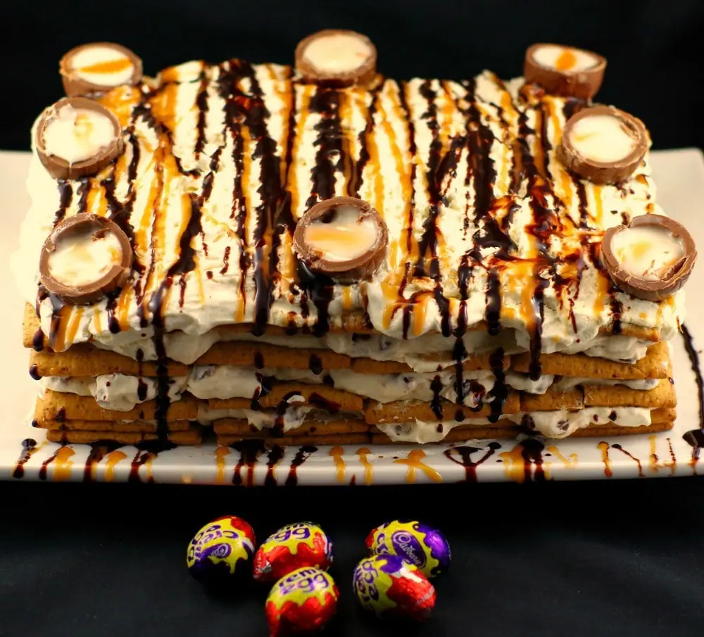 whole easter creme egg cake with some mini Easter creme eggs in front