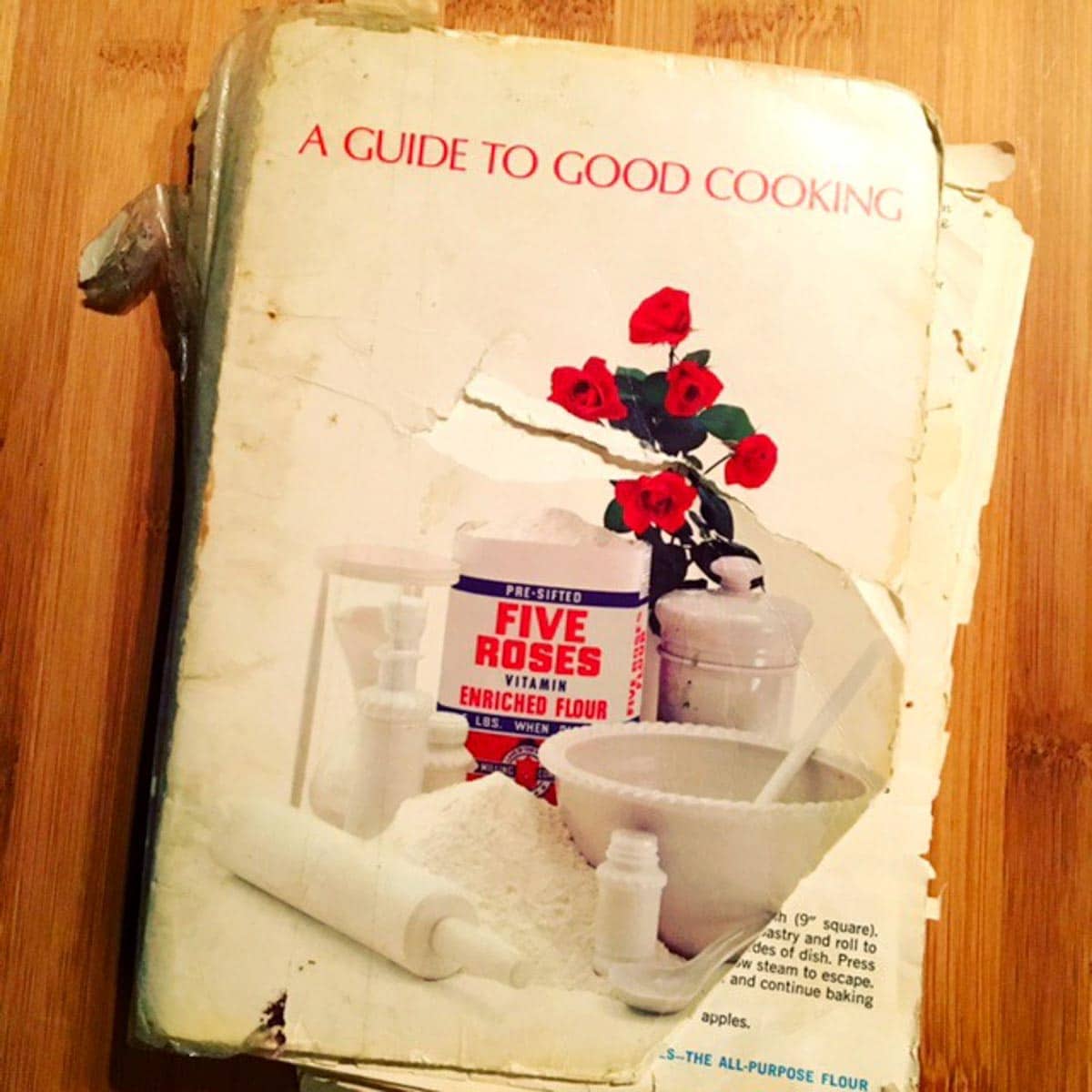 a worn out copy of the Five Roses Cookbook sitting on a table