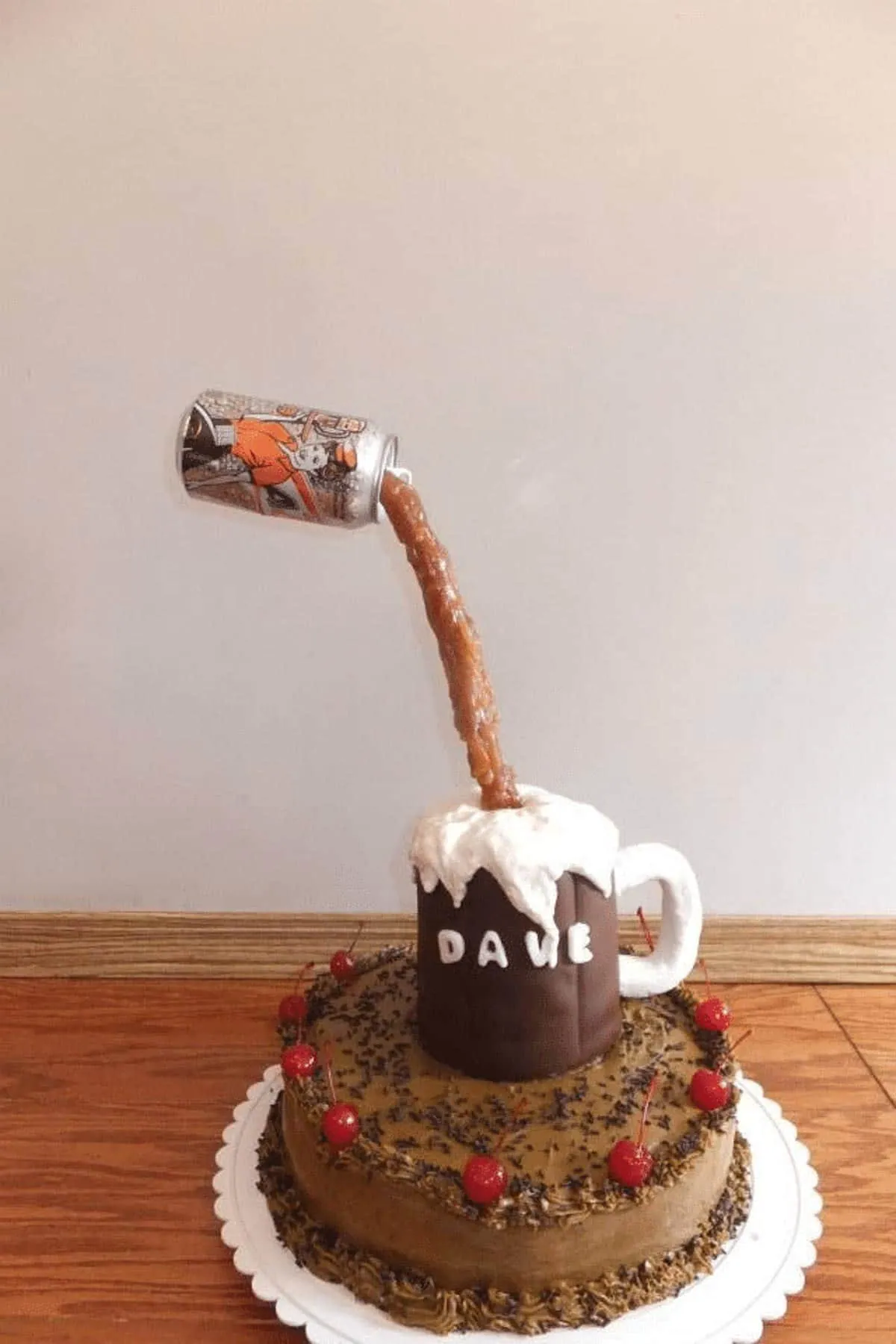 gravity defying root beer cake with can suspended in air over fondant mug, on top of root beer cake