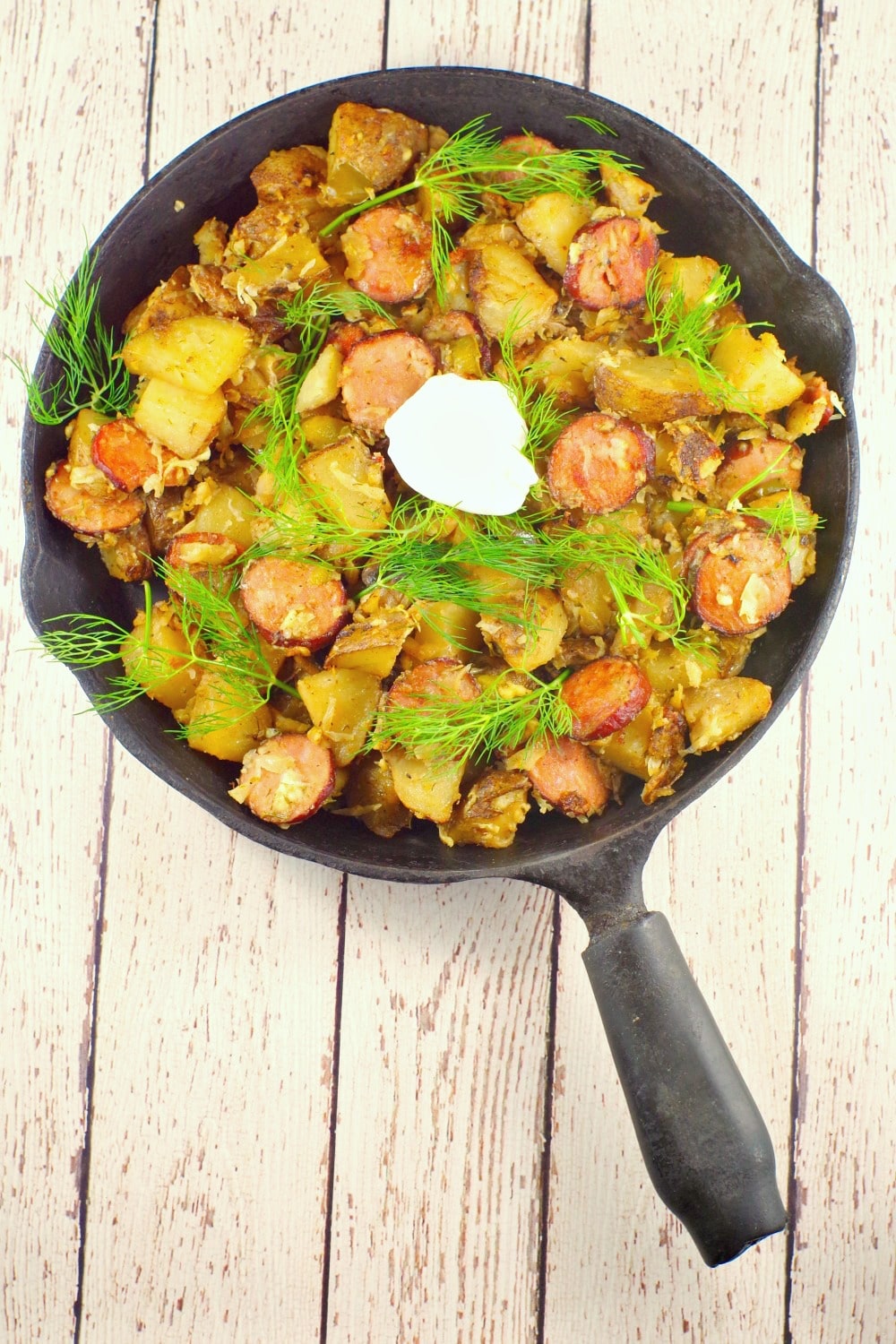 This easy Ukrainian recipe uses home made hash browns that can be made with fresh or leftover baked potatoes, dill, Ukrainian sausage, dry cottage cheese and sauerkraut for an easy and quick breakfast that's the perfect brunch potluck idea.