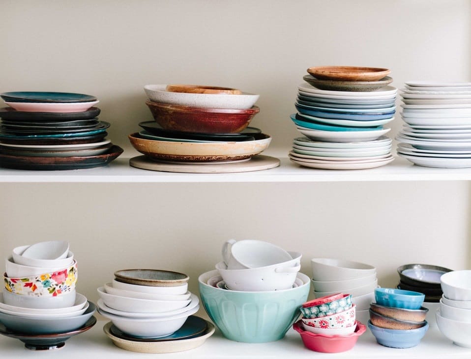 a variety of dishes on 2 shelves