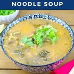 pinterest pin with photo of asian beef noodle soup and white text on blue background on top and bottom