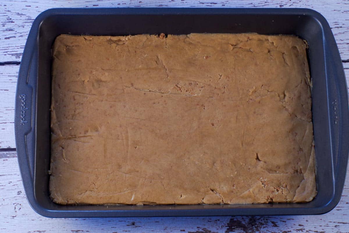 Base dough pressed into a 9x13 pan.