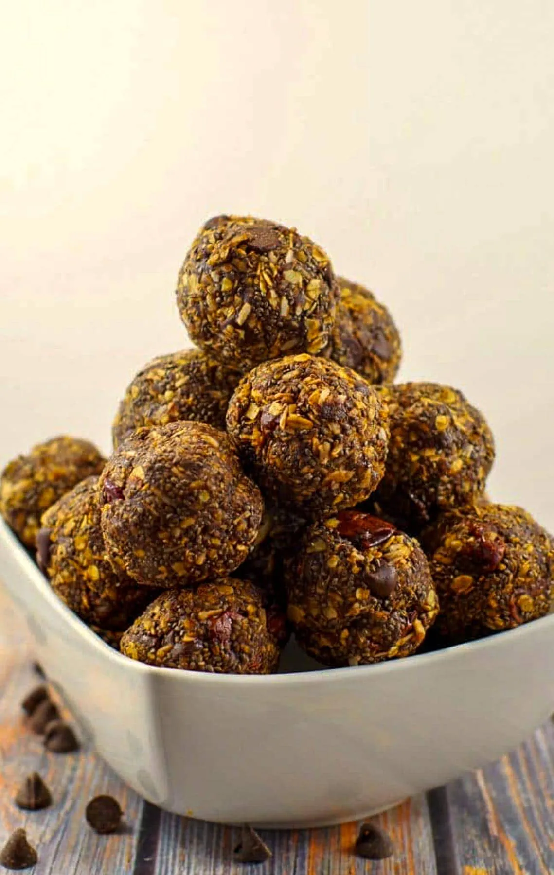 chocolate cherry energy balls stacked in a white bowl