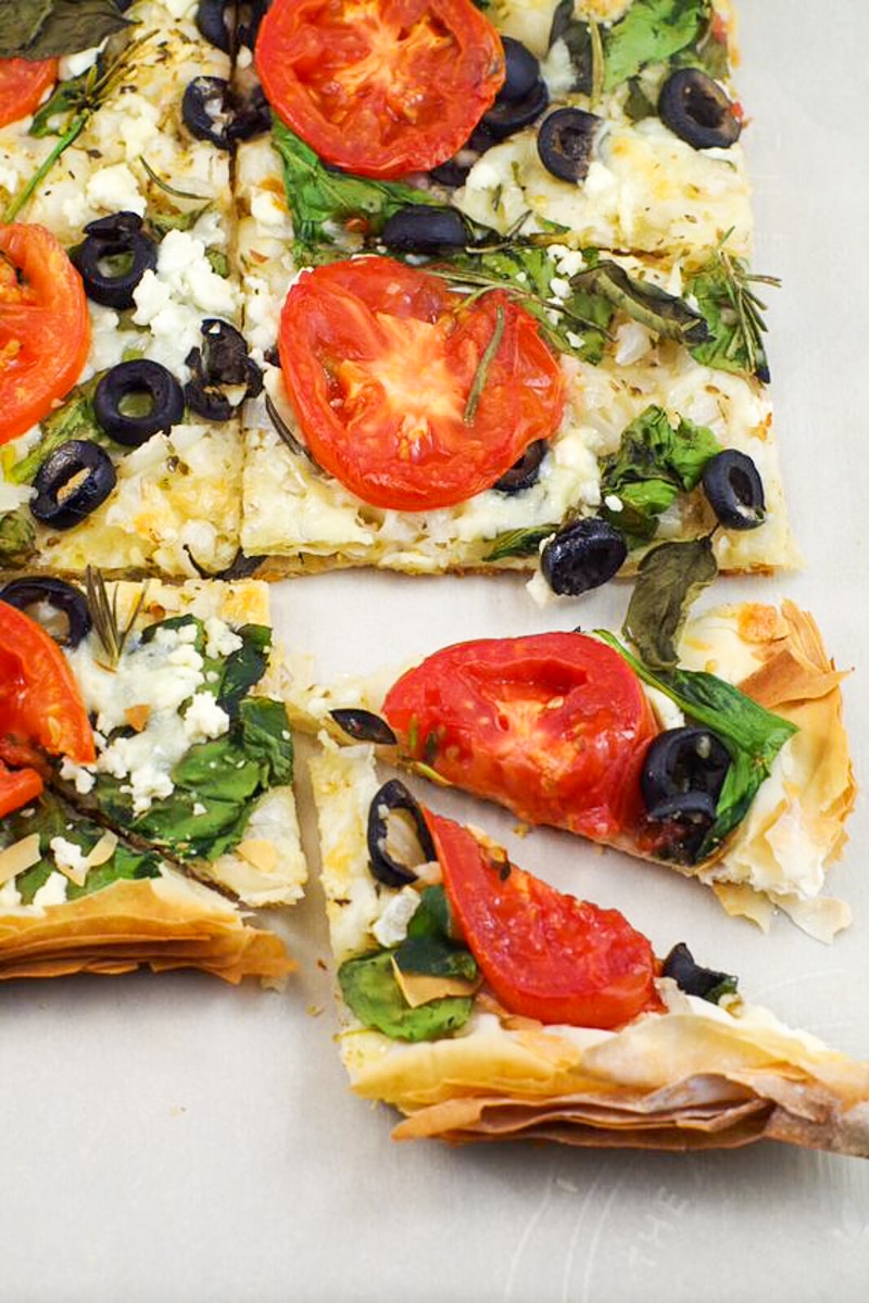 Filo Pastry pizza cut into triangles, with a couple of pieces sticking out