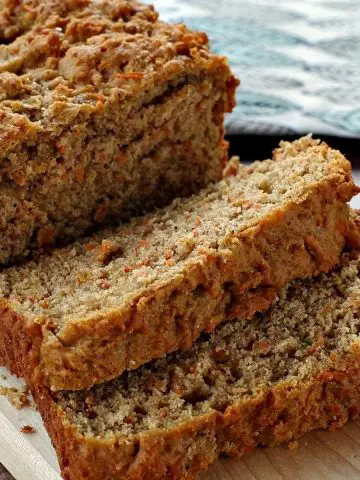 healthy carrot loaf sliced on a cutting board