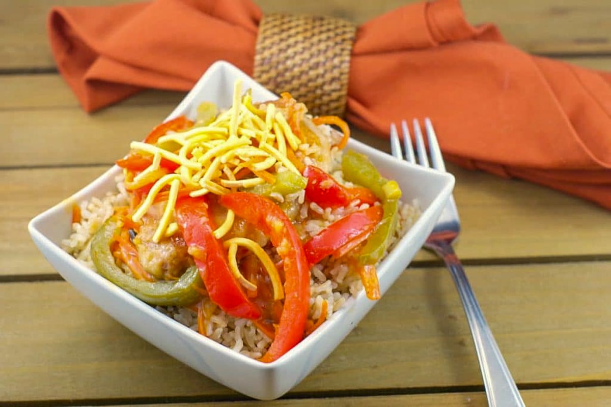 plum glazed pork chops in a white bowl with a brownish orange napkin in the background