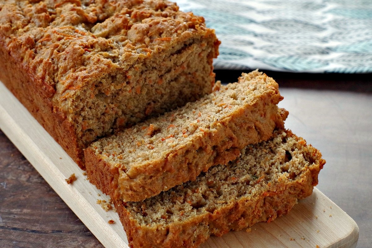 healthy carrot loaf sliced on a cutting board