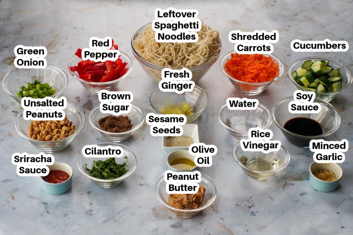 ingredients in peanut pasta salad in glass bowls, labelled