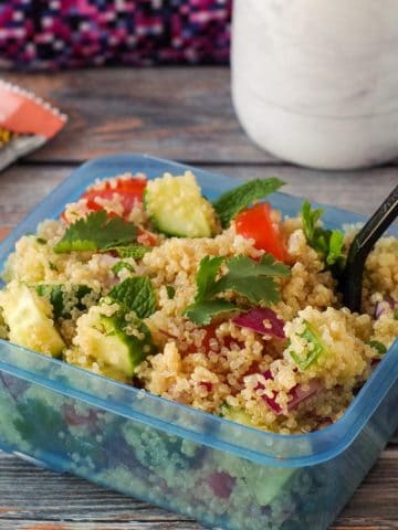 simple quinoa salad in a blue lunch container