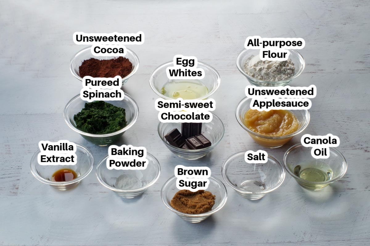 ingredients in applesauce and spinach brownies in glass bowls, labelled