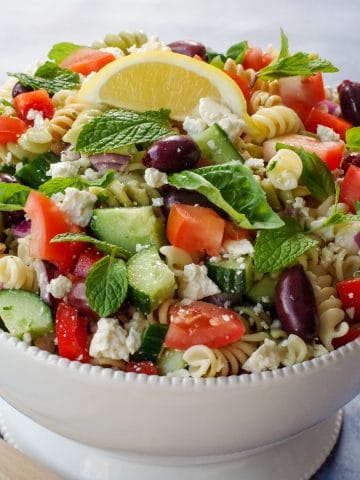 Greek pasta salad in white bowl