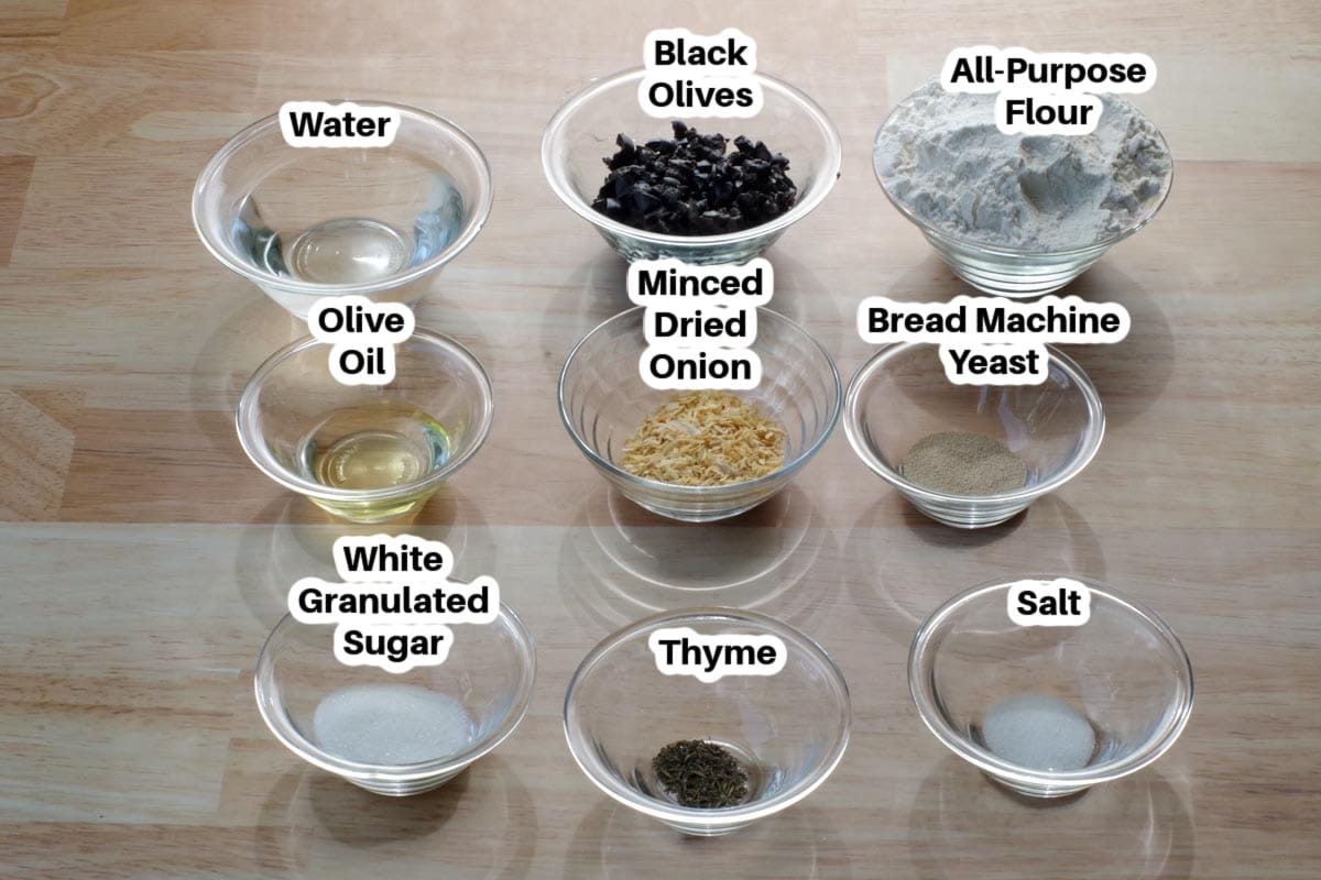 ingredients in bread maker Onion and Olive bread in glass bowls, labelled