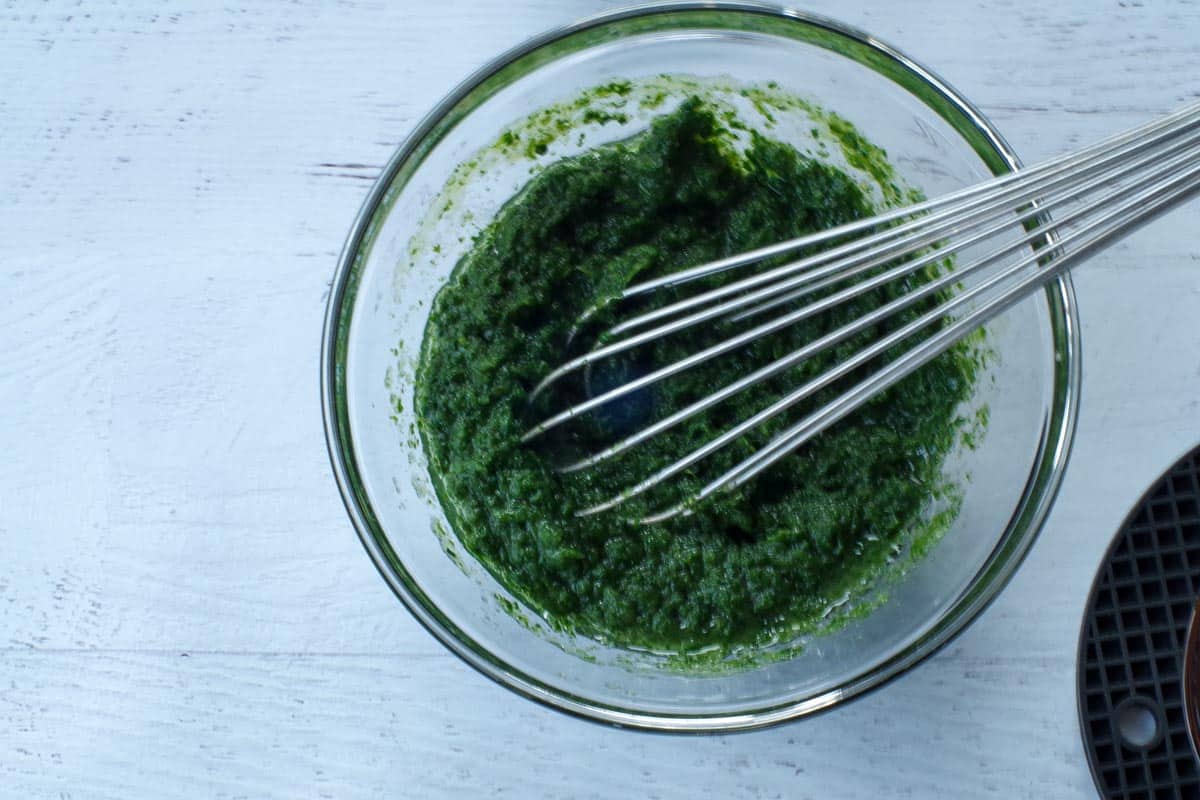 wet ingredients in a glass bowl with a metal whisk