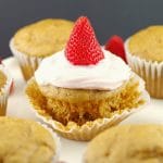 Pancake cupcake with Greek yogurt and strawberry topping, on loosened muffin liner wrapper, with other cupcake pancakes around it