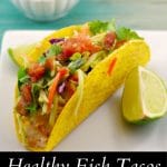 pinterest pin with white text on black background on the bottom and photo of fish taco on white plate, with wedge of lime