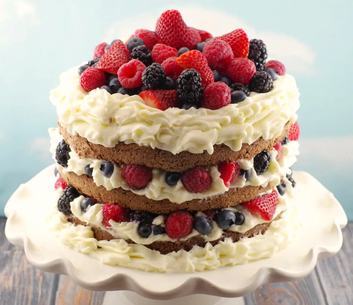 Italian Chocolate Sponge cake with summer berries, whipped cream icing and chocolate mousse