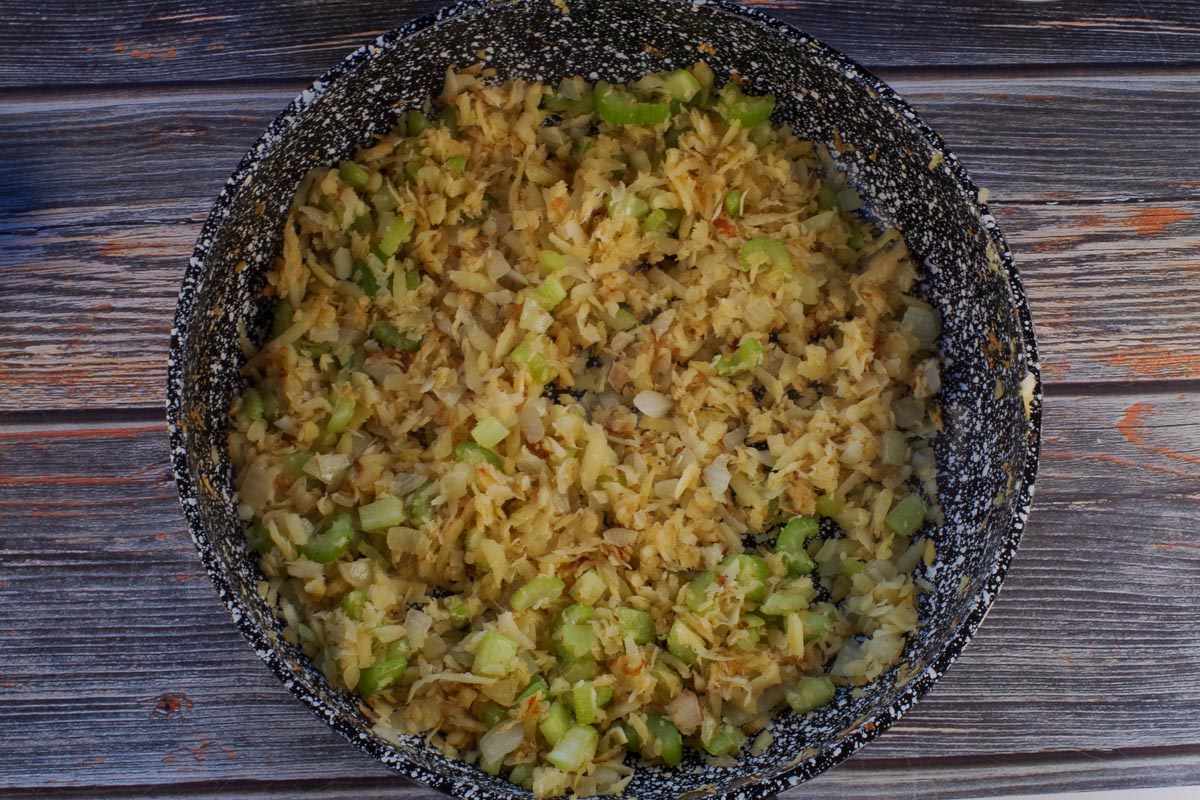 Grated parsnips, celery and onions, sauteed in frying pan.