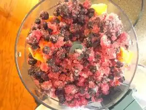 Fruit popsicle making step 3- add frozen berries to food processor