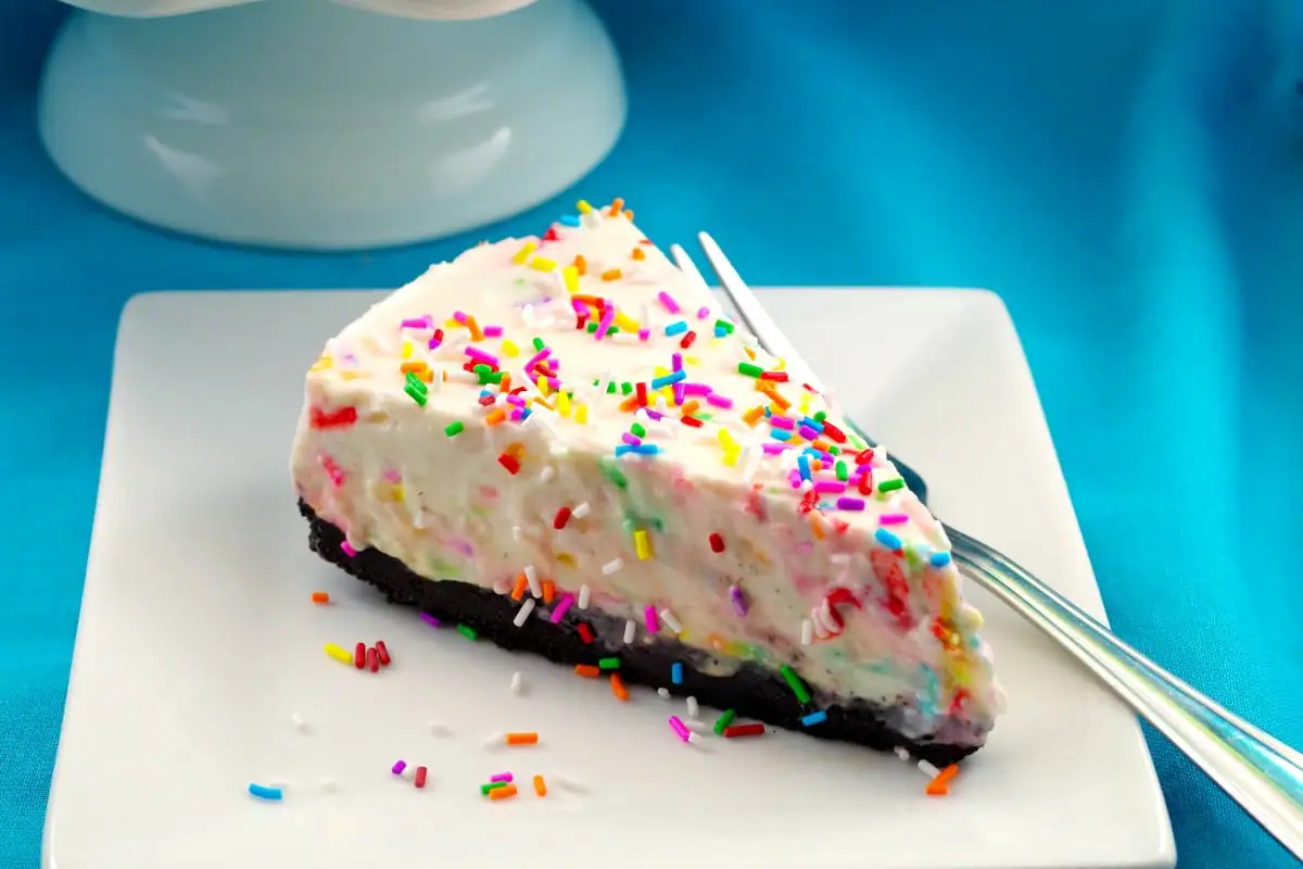 No bake birthday cake cheesecake piece - foodmeanderings.com