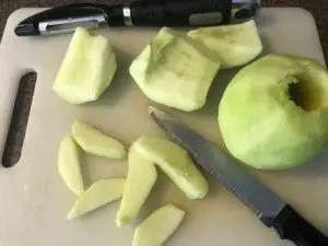 apples on cutting board, peeled and sliced