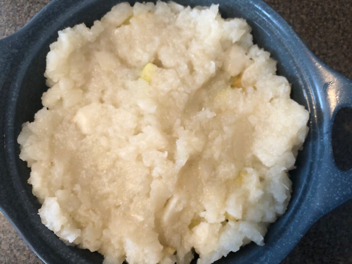 final top layer of turnips in blue casserole dish