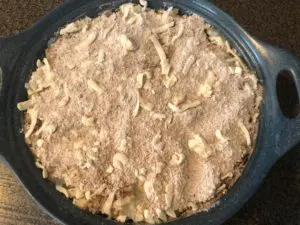 crust of flour, butter and brown sugar on top of turnips in blue casserole dish