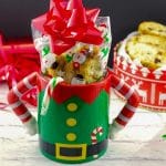 Christmas biscotti in a Christmas mug with a gift box of biscotti in the background