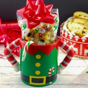 Christmas biscotti in a Christmas mug with a gift box of biscotti in the background