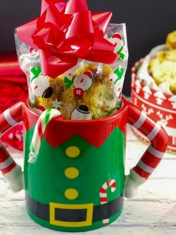 Christmas biscotti in a Christmas mug with a gift box of biscotti in the background