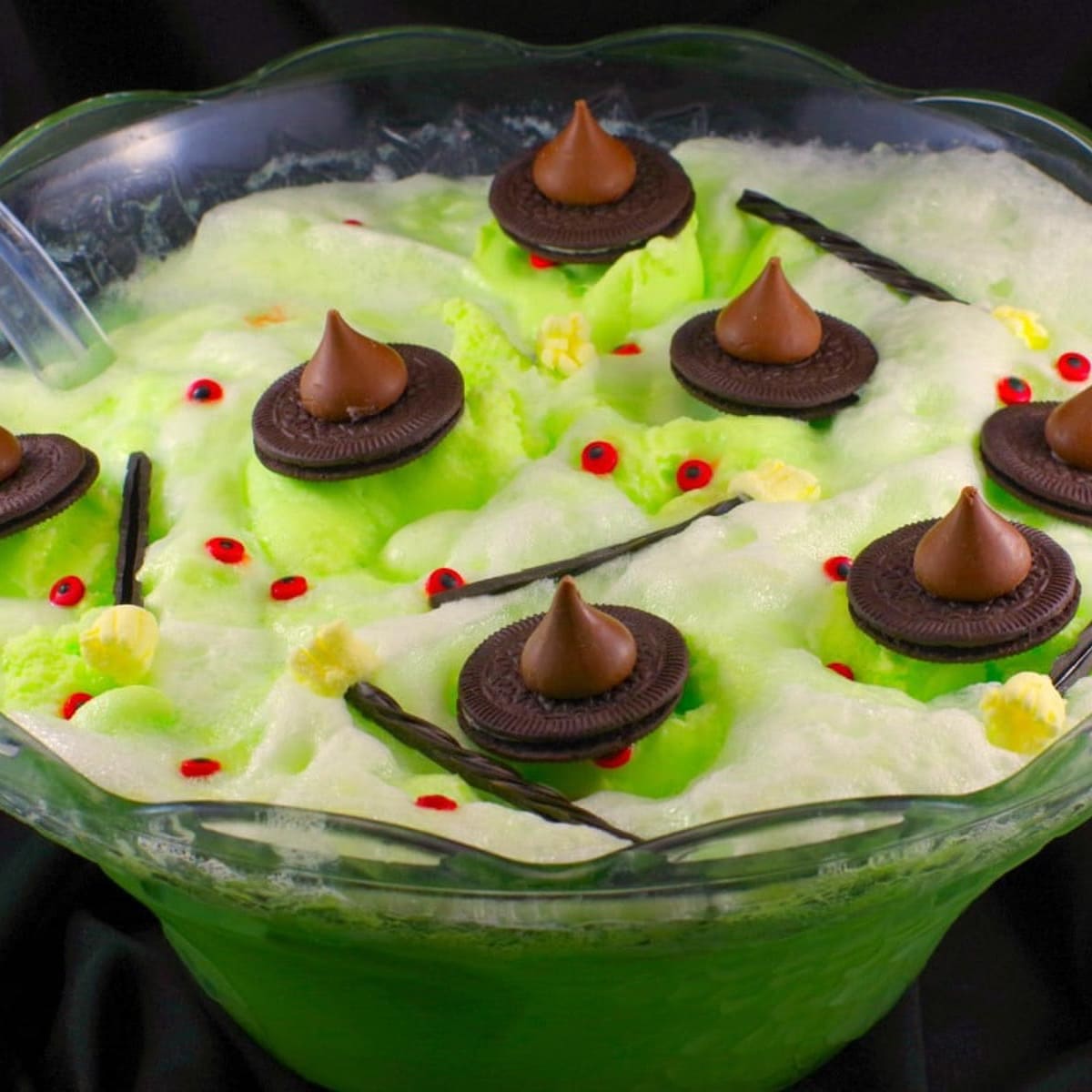 melting witch Halloween punch in punch bowl with black material in the background