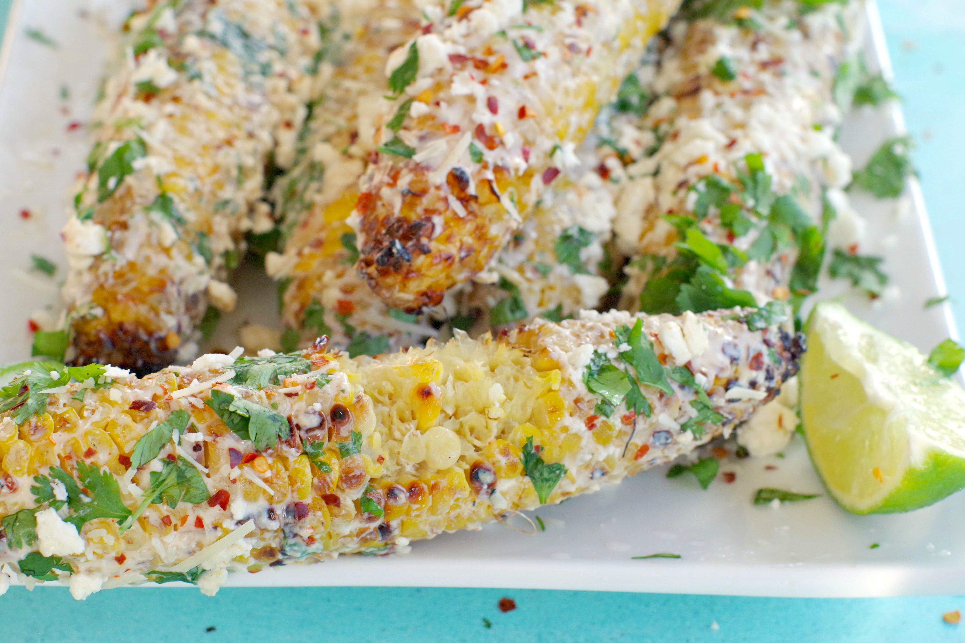 Mexican grilled corn with bites taken out of it