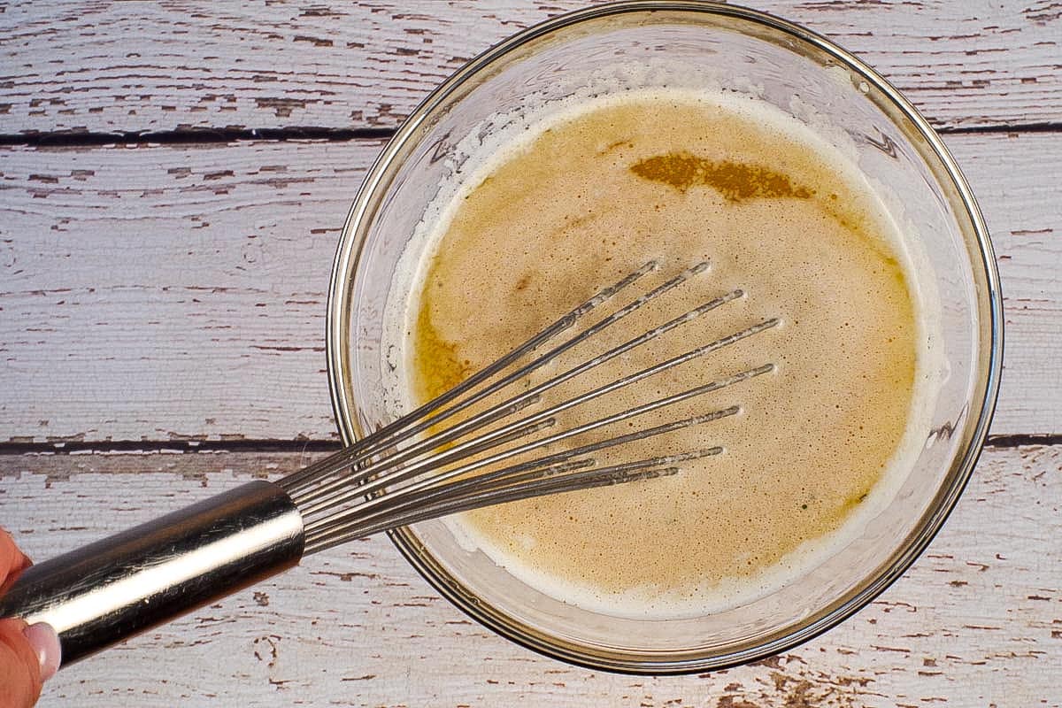 Ranch and Worcestershire Sauce whisked into butter in glass bowl with metal whisk.