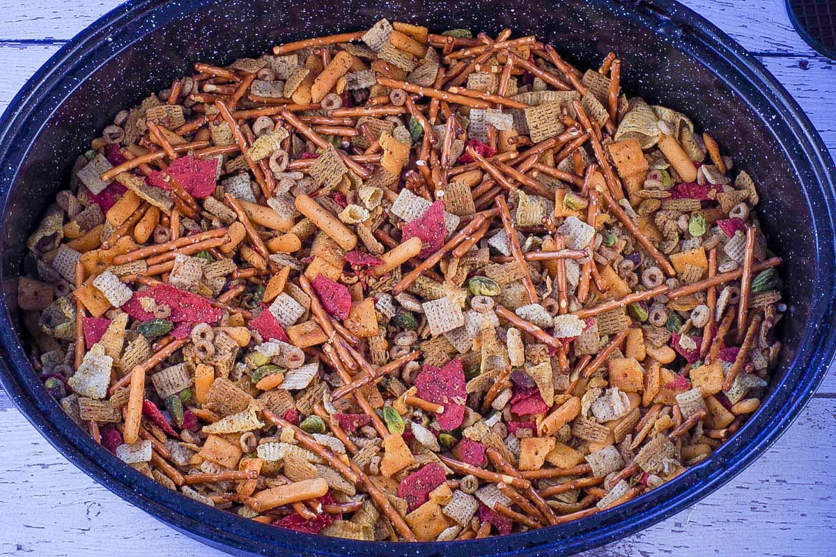 Baked snack mix in large oval roasting pan.