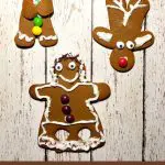 kid decorated gingerbread cookies on white board