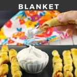 Pinterest Pin with white text on black background at top and bottom and photo of French toast pigs in a blanket being dipped in whipped cream
