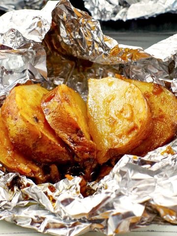 cooked, sliced, onion baked potato on foil