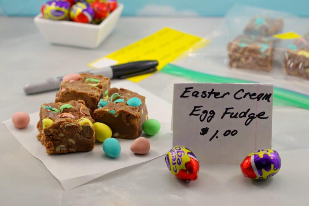 Easter Creme egg fudge on table at bake sale with sign and pen and sticker and more eggs in background