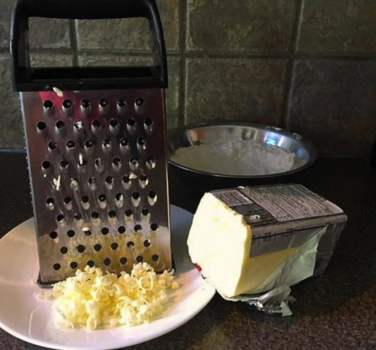 butter being cut (for pastry) with a cheese grater
