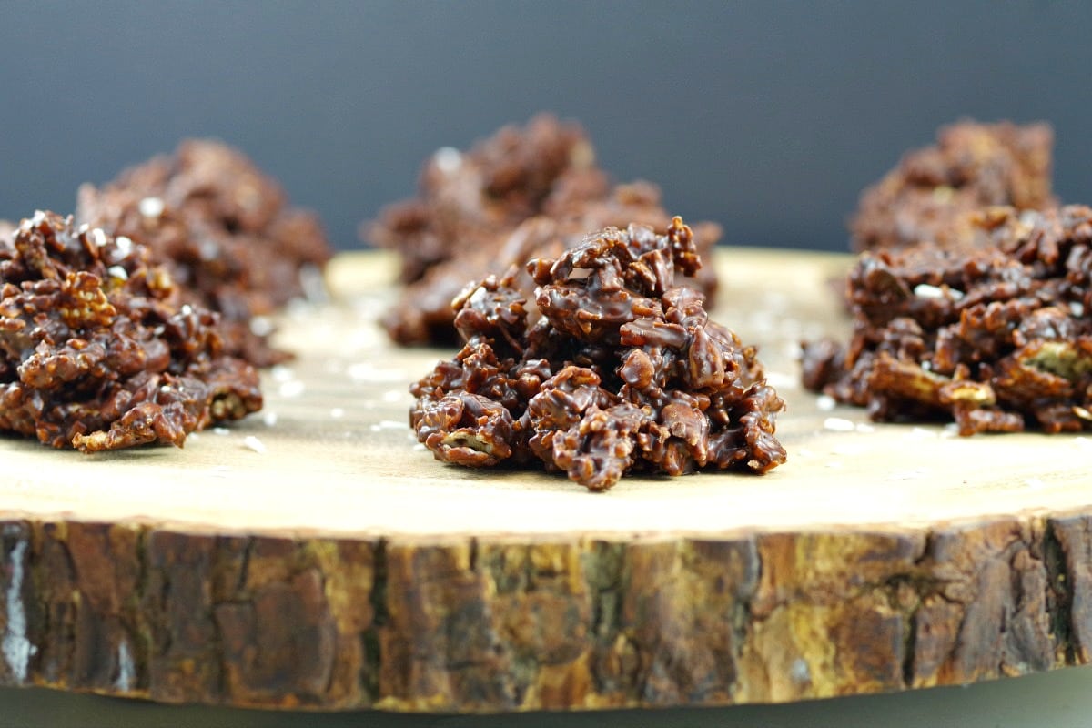 Healthy Chocolate Cluster on a wooden display with more chocolate cluster in background