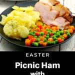picnic ham on a plate with scalloped potatoes and vegetables