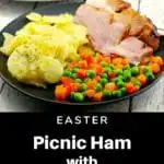 picnic ham on a plate with scalloped potatoes and vegetables