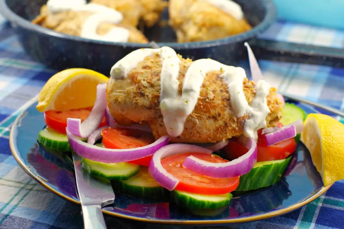 Greek Chicken breast Souvlaki with tzatziki drizzled on (with no pita and no skewer) on a bed of fresh vegetables