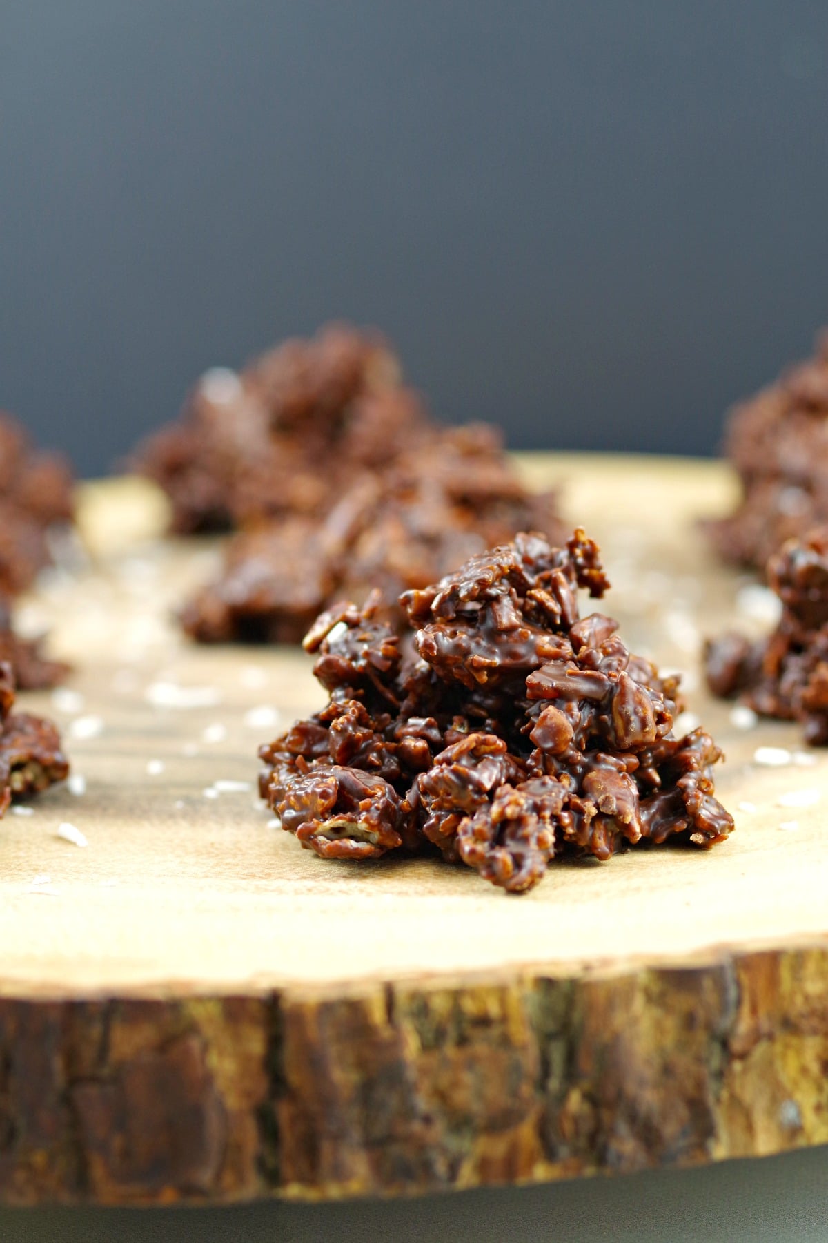 Healthy Chocolate Cluster on a wooden display with more chocolate cluster in background