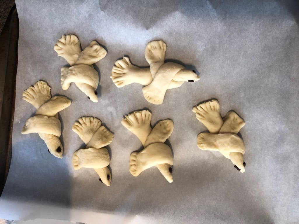 bread doves on parchment lined baking sheet
